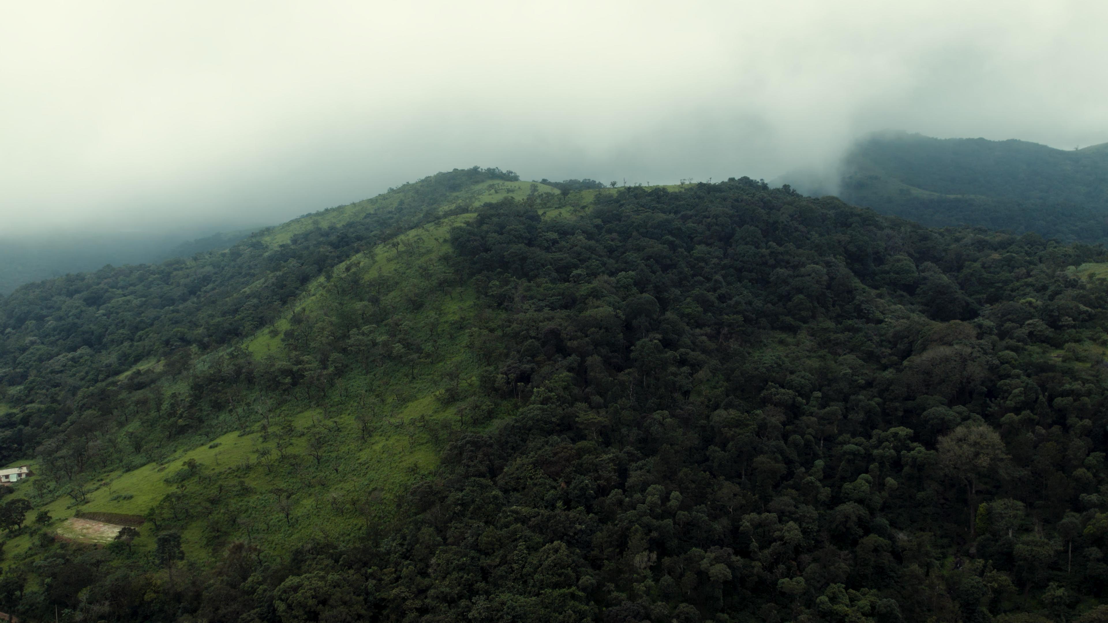 Green hill under clouds